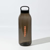 A drink bottle in smoky grey with a black lid features a logo. It has a reusable design for eco-friendly use.