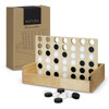 A wooden four-in-a-row game with black and white pieces, displayed with its box.