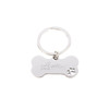 A silver dog bone keytag featuring a paw print design and an engraved logo.