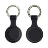 A silicone Airtag case in black with a keyring attached, featuring a smooth, round design.