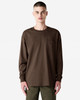 A brown Super Heavyweight T-shirt featuring long sleeves and a chest pocket, with a simple logo on the side.