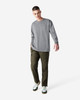 A model wears a grey long-sleeve t-shirt paired with khaki cargo pants and sneakers.