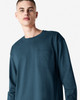 A long-sleeve super heavyweight t-shirt in dark teal, featuring a single chest pocket and a crew neckline.
