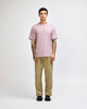 A model wearing a purple heavyweight t-shirt with relaxed-fit olive cargo pants and white sneakers.