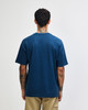 A blue American Apparel Super Heavyweight T-Shirt viewed from the back, with a simple design and a logo.