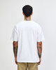 A white American Apparel Super Heavyweight T-Shirt viewed from the back, worn by a model with curly hair.