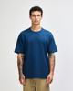 A model wearing an American Apparel super heavyweight T-shirt in dark blue, paired with olive green shorts.