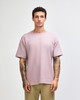 A model wearing a purple American Apparel Super Heavyweight T-Shirt, paired with olive green shorts.