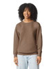 A brown crewneck sweatshirt featuring a relaxed fit. The model has curly hair and is smiling. The sweatshirt has a logo.