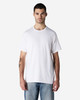 A white Gildan Light Cotton T-Shirt displayed on a male model, featuring a simple design and relaxed fit.