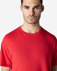 A red Gildan Light Cotton T-Shirt displayed on a model, featuring a simple design and a logo.