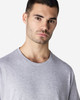 A plain grey Gildan Light Cotton T-Shirt worn by a model, featuring a simple crew neckline and short sleeves.
