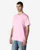 A plain pink Gildan Light Cotton T-Shirt displayed on a model, featuring a classic fit and short sleeves.