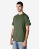 A green Gildan Light Cotton T-Shirt displayed on a model standing against a plain background.