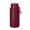 A drink bottle in burgundy, featuring a lid with a straw and a carrying loop. It has a logo on the side.