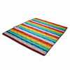 A brightly coloured picnic blanket featuring a quilted design with rainbow stripes in red, blue, yellow, and white.