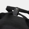 A black canvas cooler bag featuring sturdy straps and a snap button closure. It has a simple design with no visible branding.