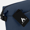 A navy blue soft-touch toiletry bag featuring a branding tag. The bag has a zip closure and a sleek design.