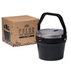 A black ice bucket with a lid and handle, placed next to a plain cardboard box featuring a logo.