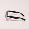 Transparent framed sunglasses with black arms, featuring a logo on the side.