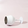 A white Shiraz detachable wine glass featuring a sleek design, displayed on a soft pink background.