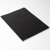 A black notebook with a textured cover, open with white pages visible. It has a simple, sleek design and no branding.