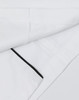 A unisex executive chef jacket in white with black detailing and a logo on the fabric.