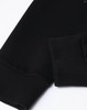 A black unisex crew neck sweater featuring airlayered CVC fabric with ribbed cuffs. It has a logo on the design.