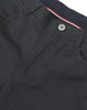 A close-up of black ladies' flexi chino pants, featuring a button and zip fly, with a hint of red and white detailing.