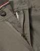 A close-up of grey chino pants showcasing a zippered fly and button closure, with a hint of contrasting interior detail.