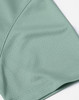 A close-up of a mint green jacquard knit fabric, showcasing its texture and pattern detail.
