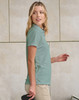 A light green ladies' sustainable jacquard knit short-sleeve polo shirt displayed on a model, with a logo visible.