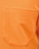 An orange safety polo shirt featuring a patch pocket and branded logo on the side.
