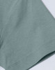 A close-up of a light blue short-sleeve cotton T-shirt with a smooth finish and a small logo.