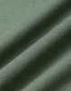 A close-up of folded fabric in a soft, muted green colour, showcasing a smooth texture with subtle ribbing.