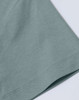 A close-up of a ladies' premium short-sleeve tee shirt in a soft green colour, featuring a smooth fabric texture.