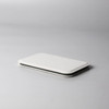 A pocket mirror in sleek white, featuring a minimalist design, resting on a light grey surface.