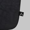 A black laptop bag features a smooth texture and a small branding tag in the corner.