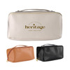 A toiletry bag in beige, with a gold logo, accompanied by orange and black versions. Features a zipper and handle.