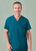 A unisex teal V-neck scrub top with a pocket, worn by a model. The top features a simple design and a logo.