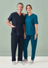 Unisex Pulse Straight Leg Scrub Pant in navy, paired with a matching scrub top, worn by a man and woman.