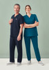A pair of jogger scrub pants in navy and teal, worn by a man and woman, standing together with casual footwear.