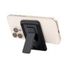 A phone with a black stand attached to the back, featuring a textured exterior. The phone is gold in colour.
