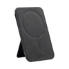 A black phone stand with a circular magnetised area and stitching details, featuring a logo on the surface.