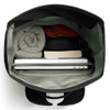 A black rolltop bag with a grey interior, containing a laptop, a book, and rolled clothing.