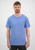 A short sleeve tee in a light blue colour, featuring a logo and worn by a male model.