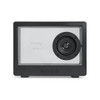 A black speaker with a transparent front and a visible speaker driver, featuring control buttons below.
