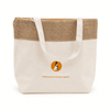 A jute and cotton cooler bag in cream and tan with a logo on the front, featuring sturdy handles.
