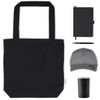 A black tote bag, grey cap, notebook, pen, and stainless steel drink container arranged together.