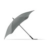 A grey BLUNT Classic Umbrella with a unique, aerodynamic shape and a curved canopy, featuring a logo on the handle.